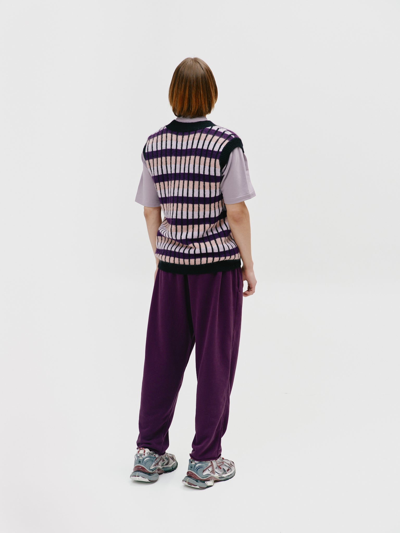 Side view of the model wearing the vibrant vest, demonstrating its flattering silhouette and comfortable fit