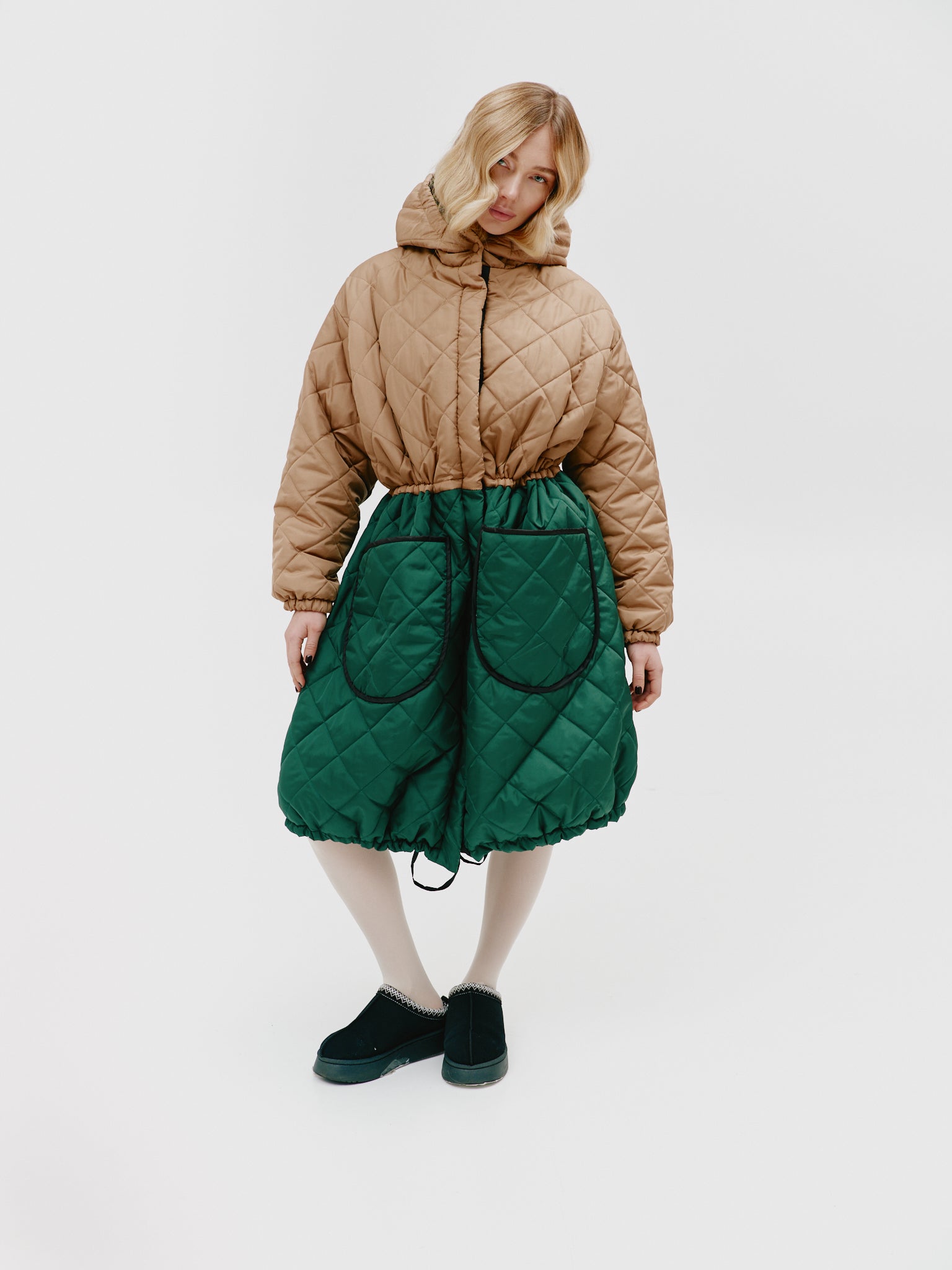 Close-up of the large pockets on the two-tone quilted jacket, emphasizing their practicality and style