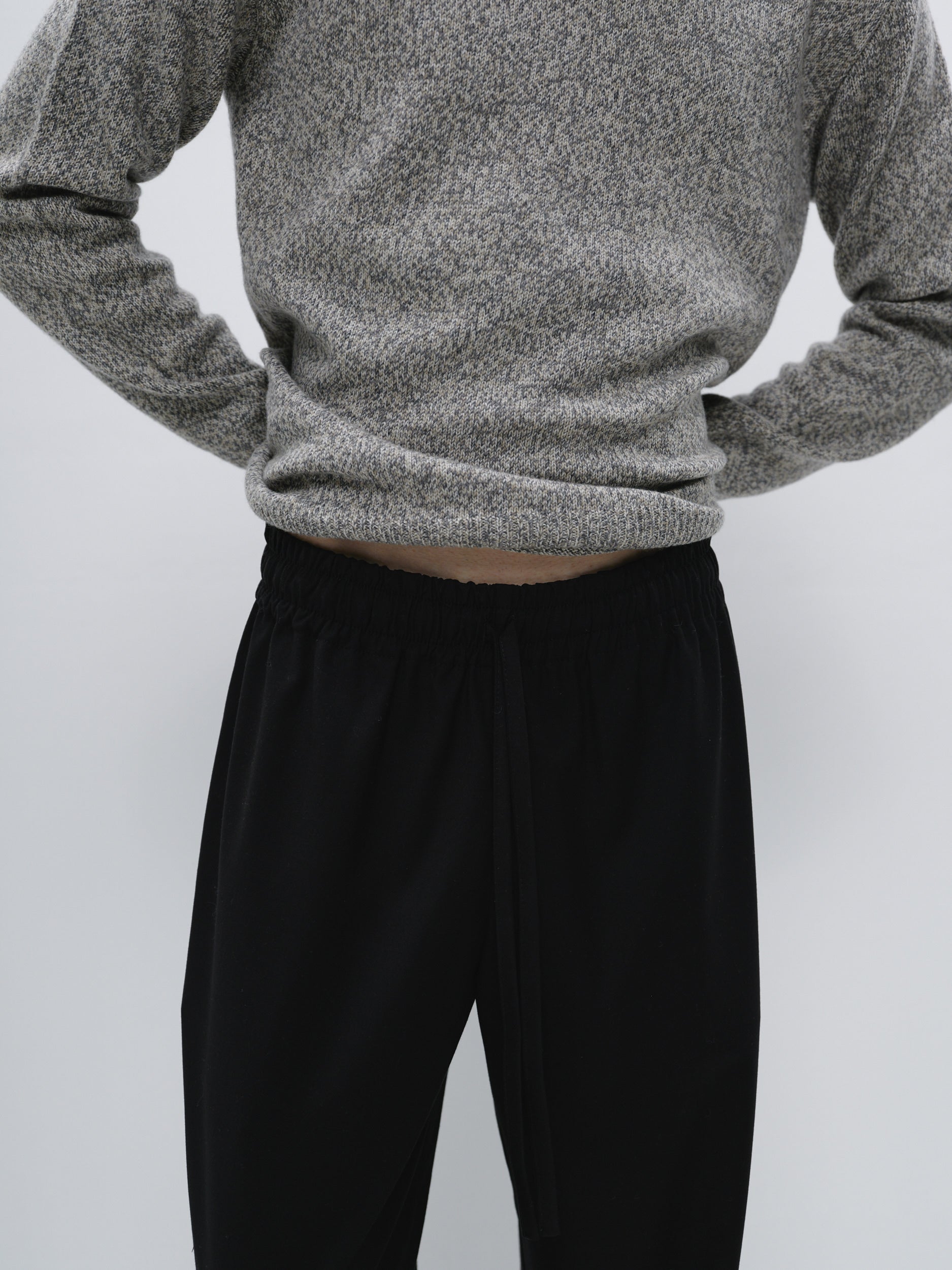 Close-up view of the suiting fabric used in the wide-leg pants, highlighting the texture and high-quality finish of the material