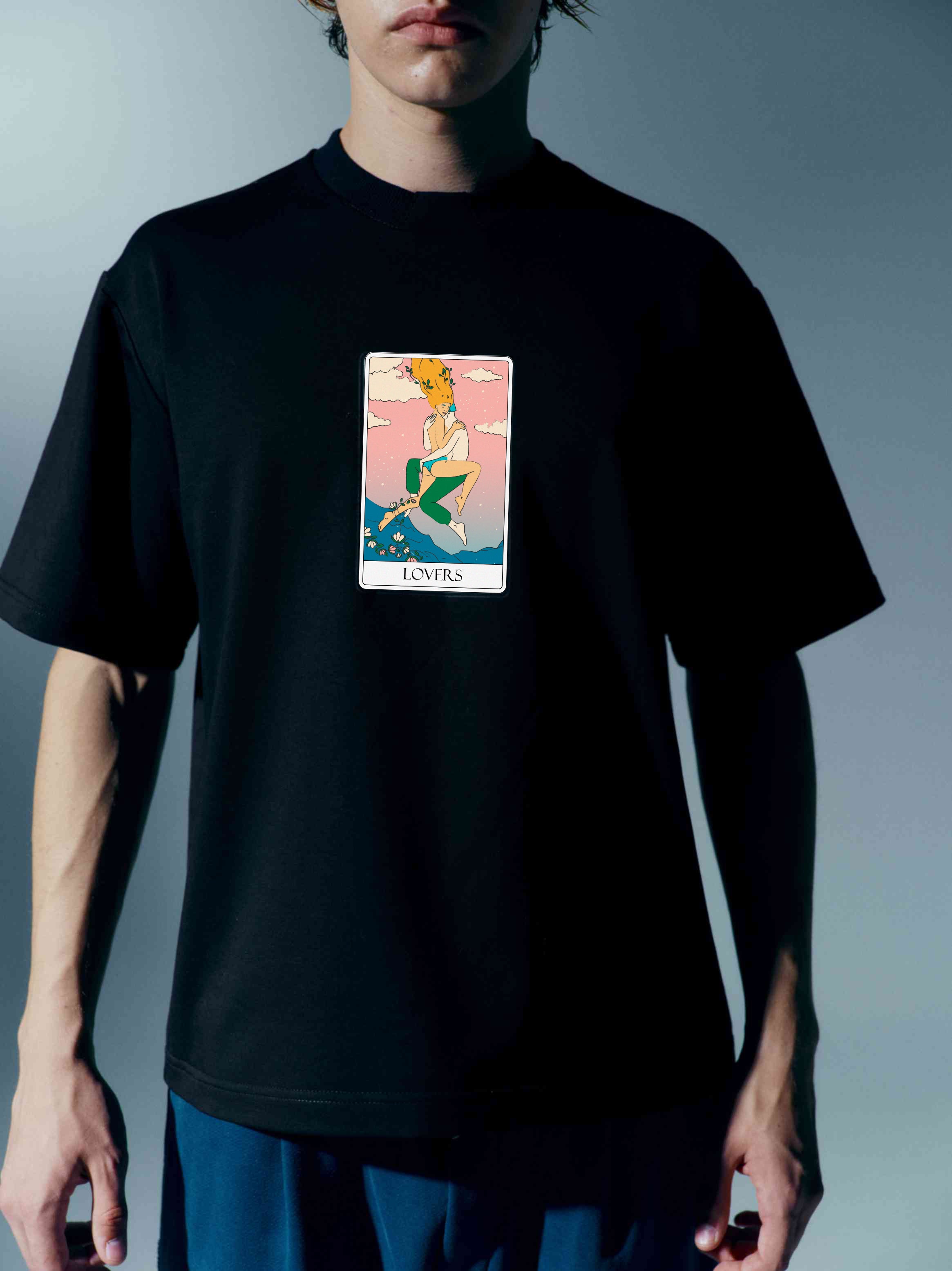 Detailed shot of a unisex cotton t-shirt with a bold Tarot card print, inspired by moon imagery, showcasing the mystical allure and modern design with a stand-up collar