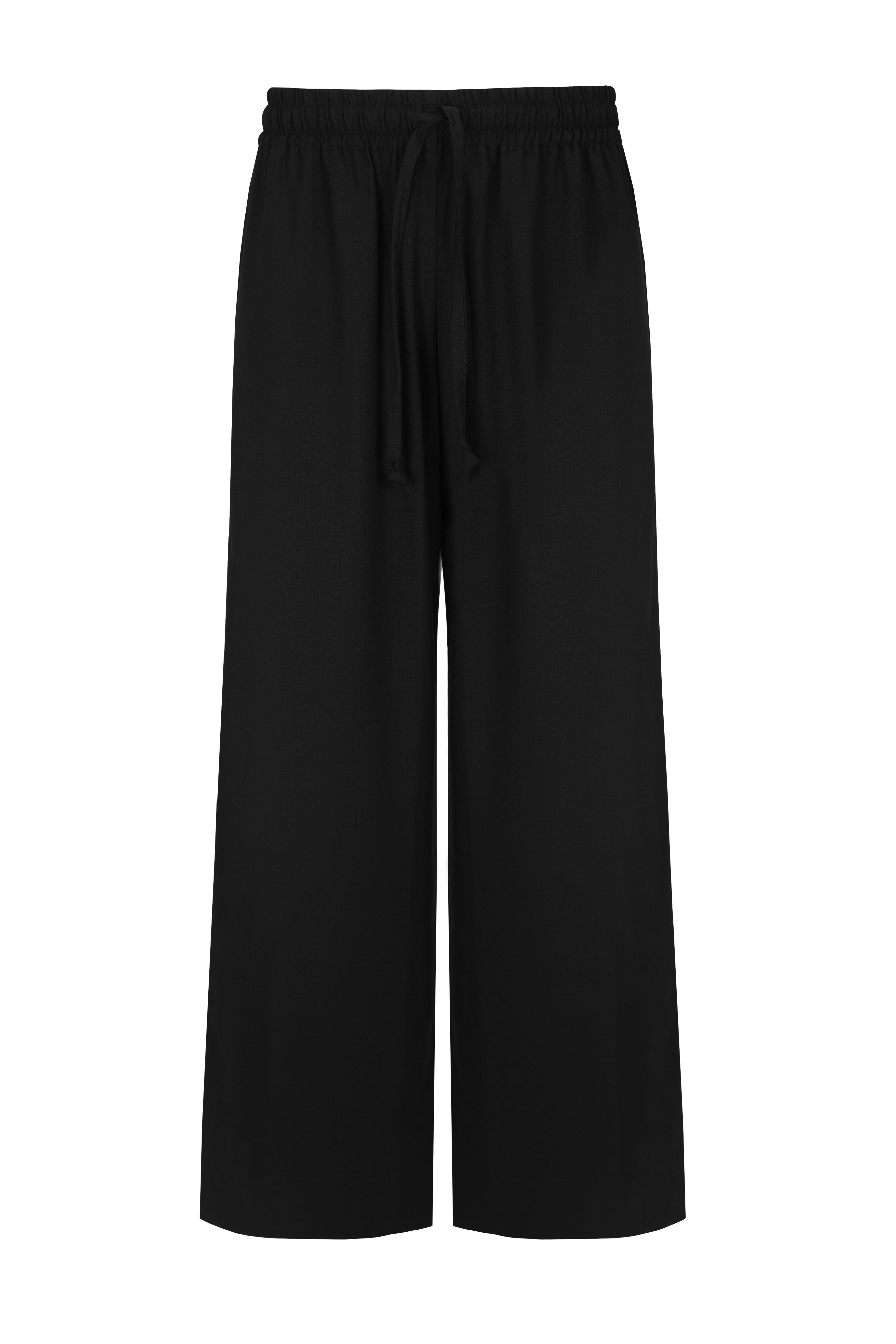 Side view of the model wearing full-length wide-leg pants made from suiting fabric, offering a chic and polished silhouette with a modern twist