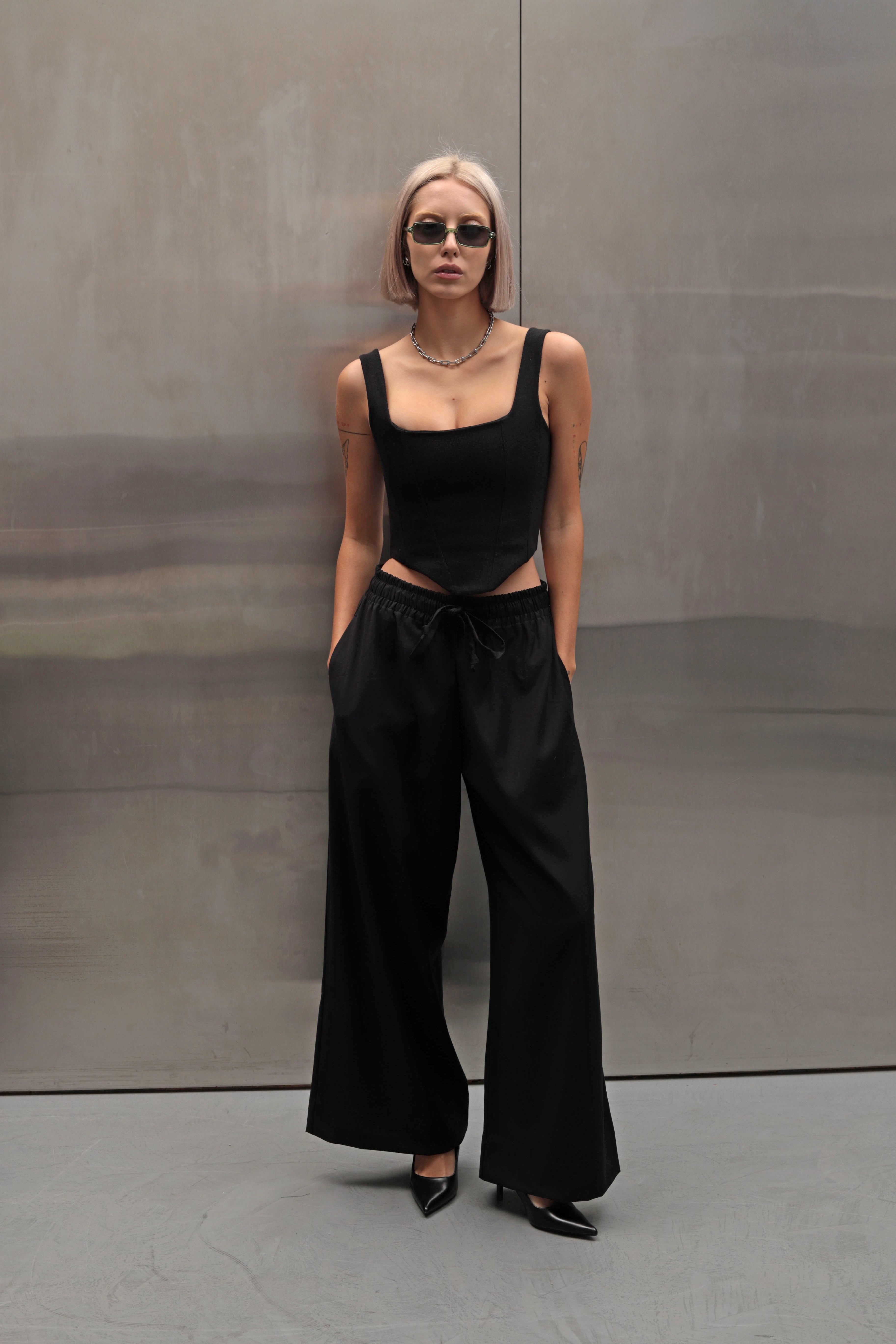 Close-up of wide-leg pants made from suiting fabric, showcasing the elastic waistband and soft texture of the high-quality fabric
