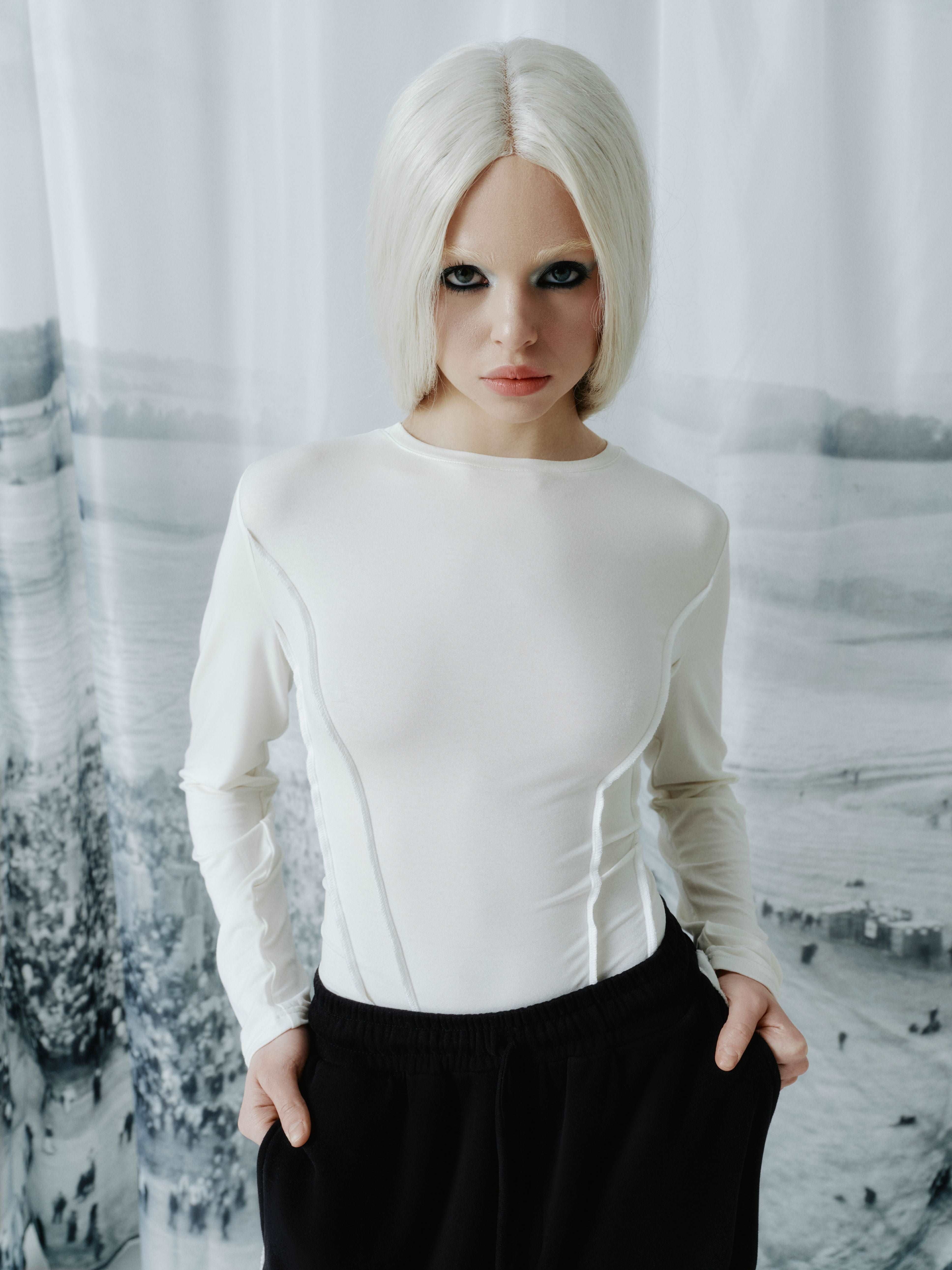 Close-up view of the front seams on the long sleeve top, emphasizing the corset-like design that adds an edgy, body-enhancing detail to the piece