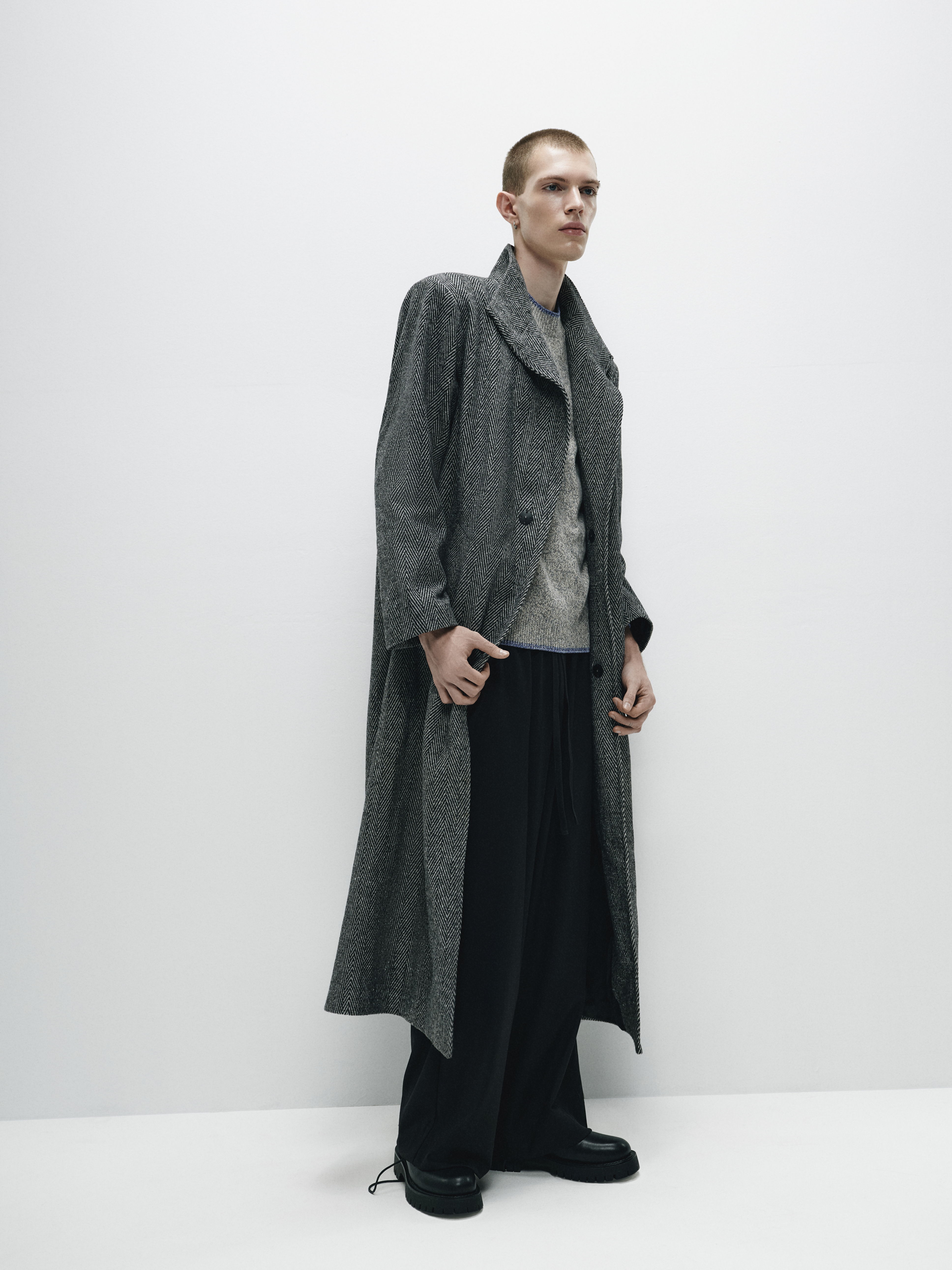 Side view of the coat, showcasing its sophisticated drape and balanced fabric weight