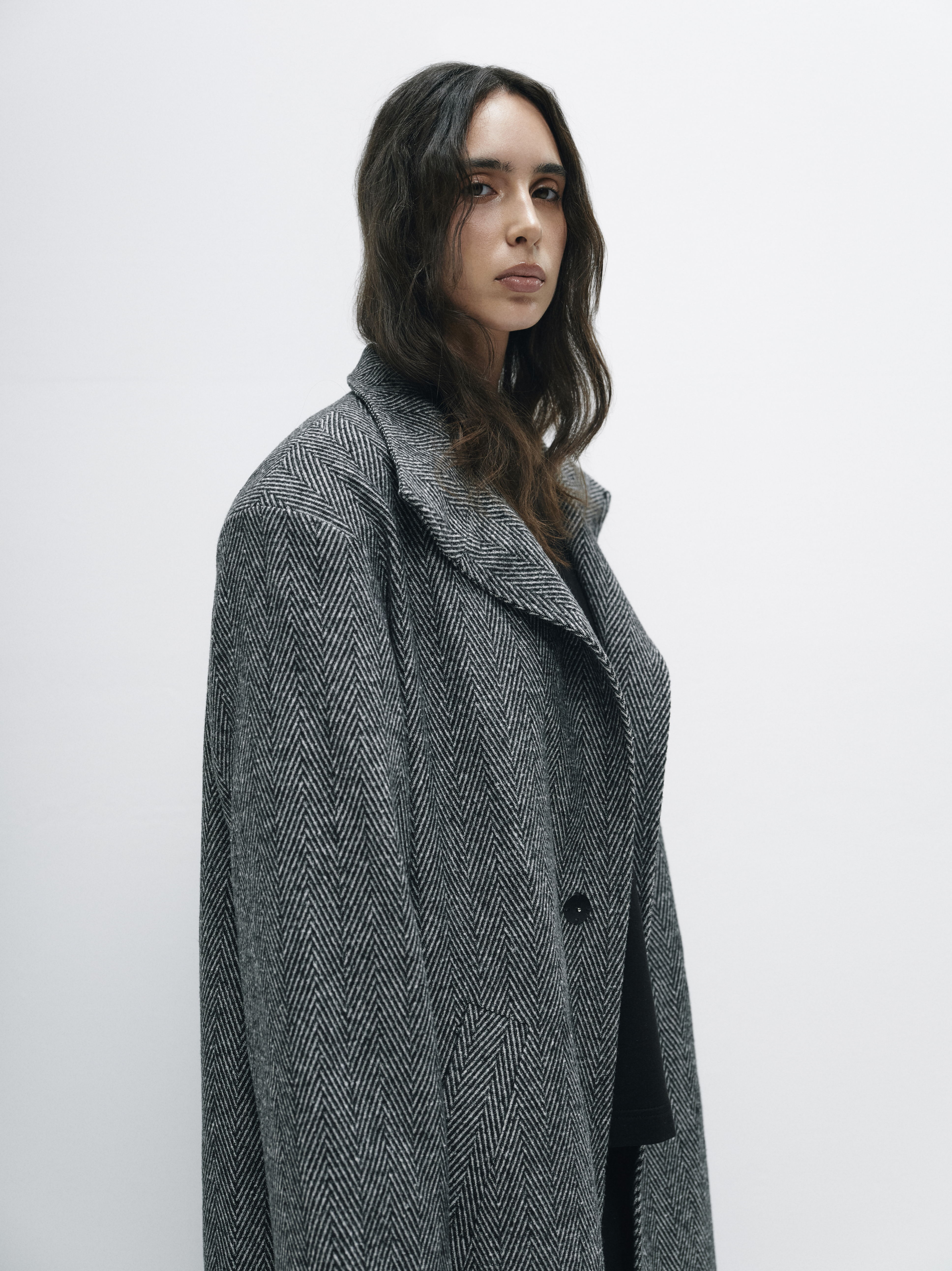 Close-up of the coat's textured fabric, illustrating its substantial yet refined composition