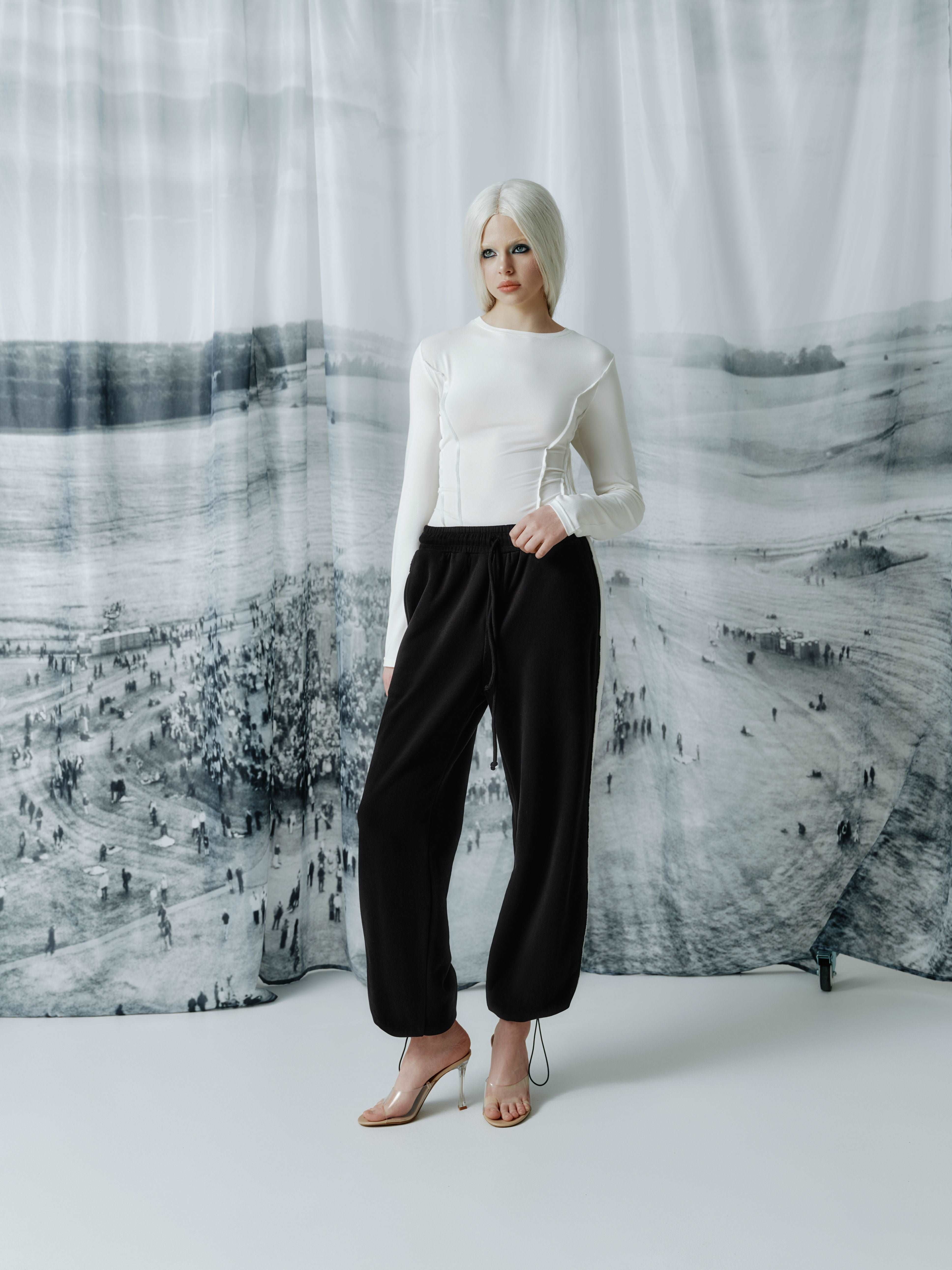 Model wearing a long sleeve top with corset-inspired front seams, showcasing its streetwear style and structured yet comfortable design