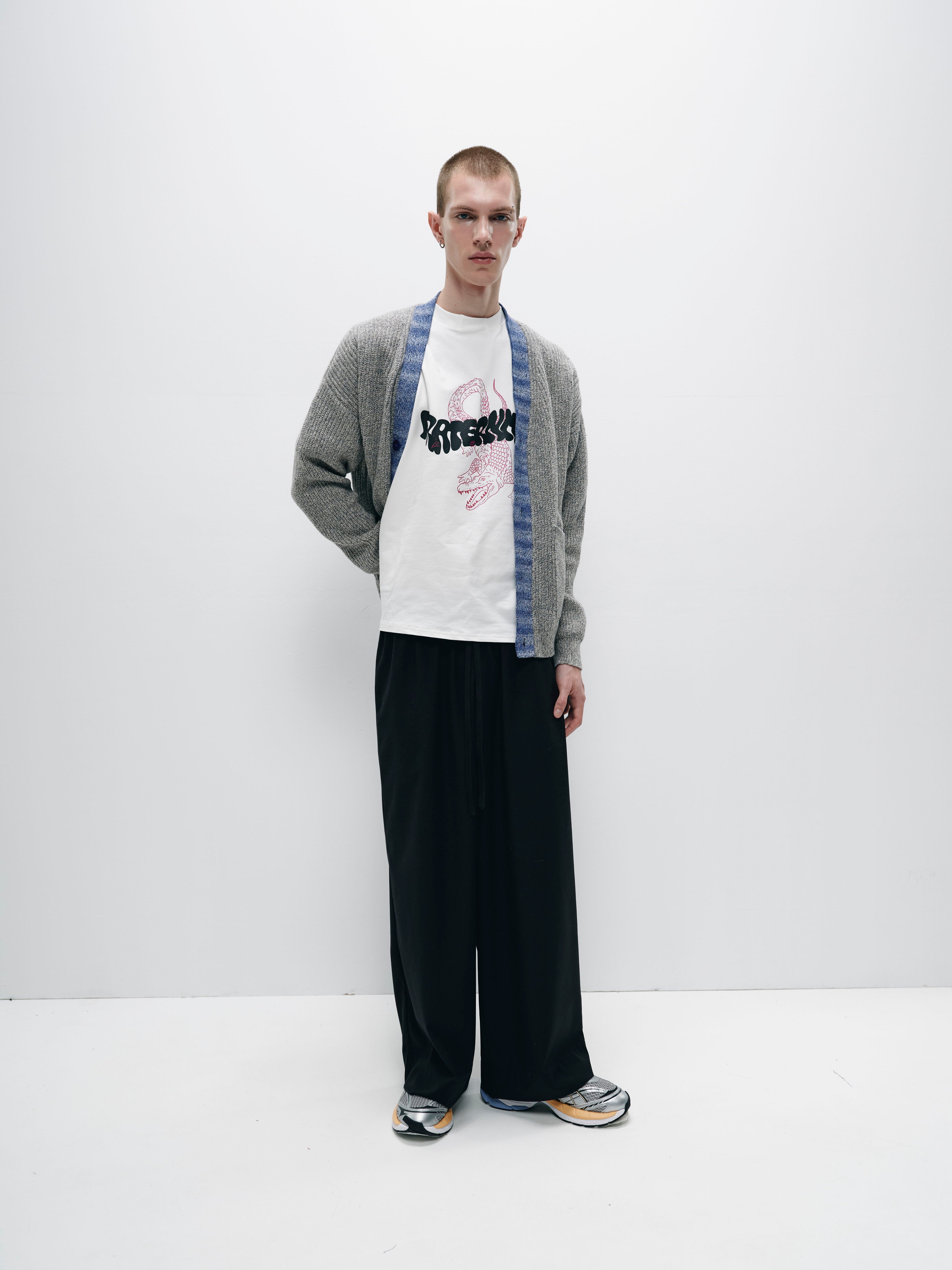 Model wearing the gray merino wool cardigan in a cozy indoor setting, illustrating the perfect combination of elegance and everyday wearability