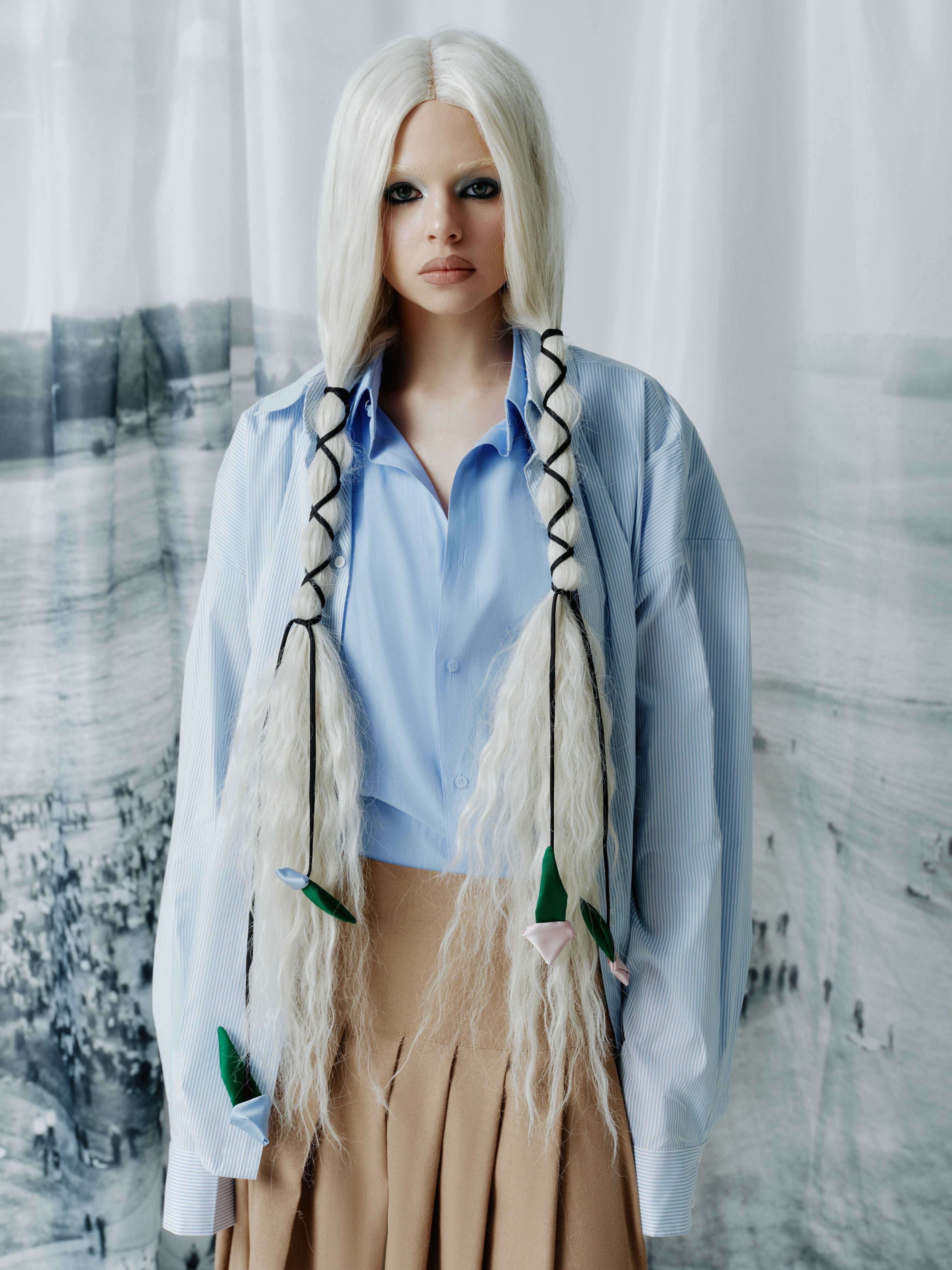 Model wearing a loose-fit shirt with double-layered fabric on the front, showcasing the effect of wearing two shirts in one