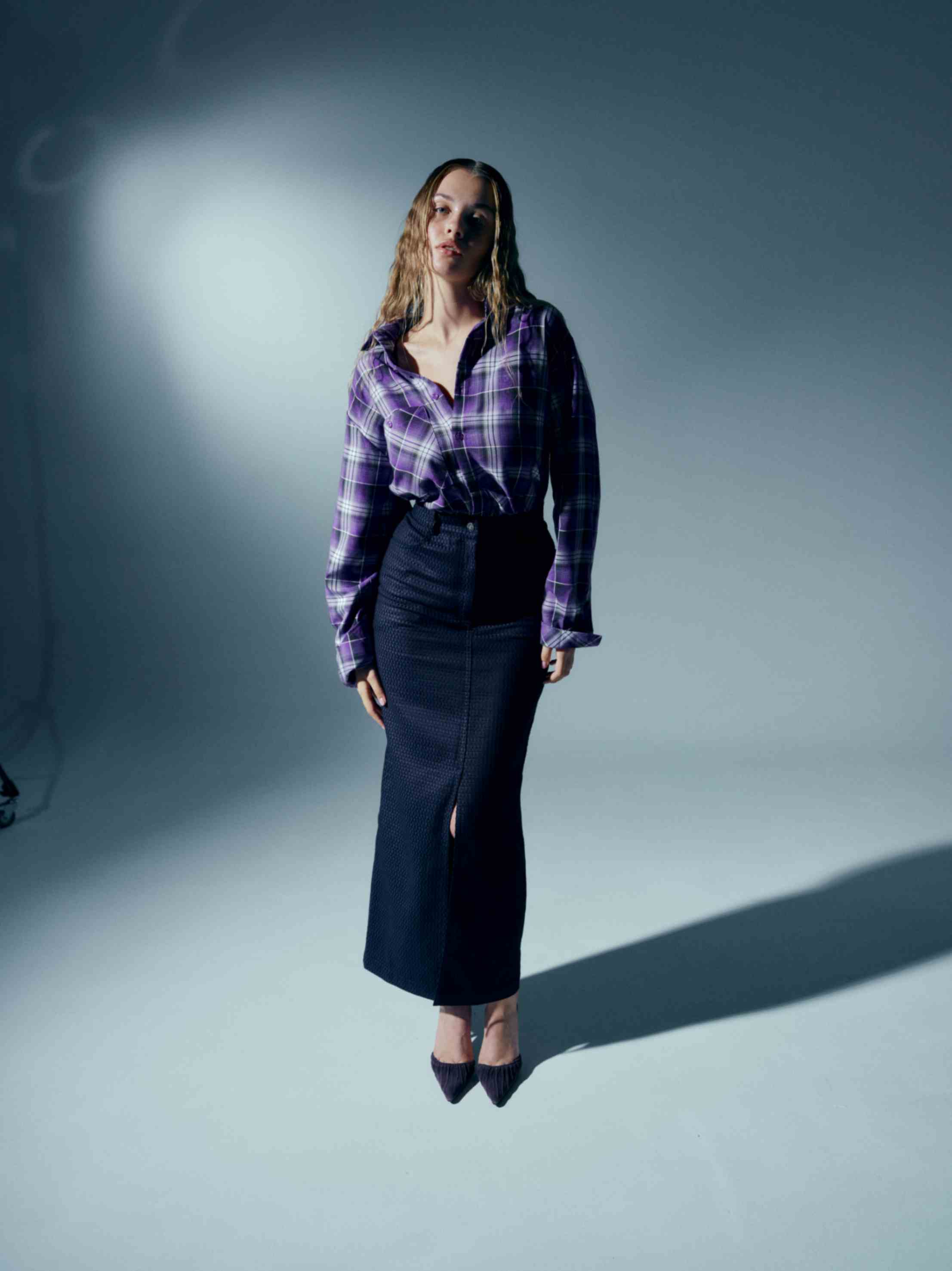 Detailed view of the front slit on the pencil skirt, adding a touch of sophistication to its sleek silhouette