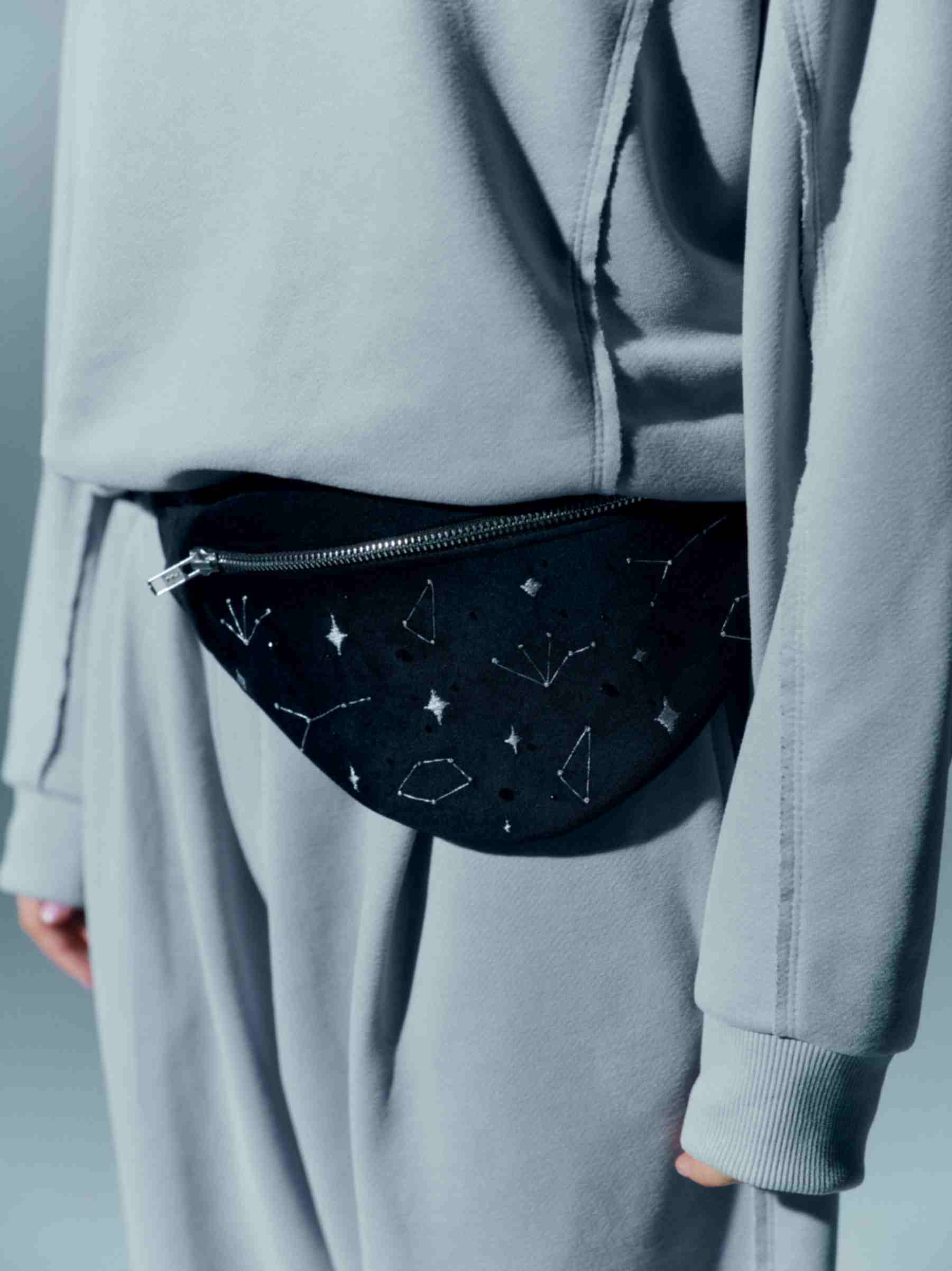 Model styling the velvet waist bag over the shoulder, offering a different way to wear this versatile accessory