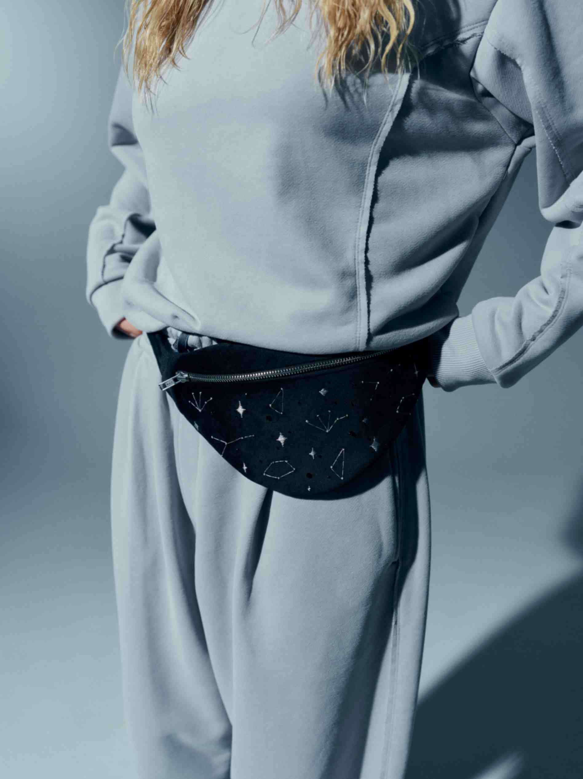 Close-up view of the velvet waist bag's side, featuring the luxurious velvet fabric and decorative crystal accents