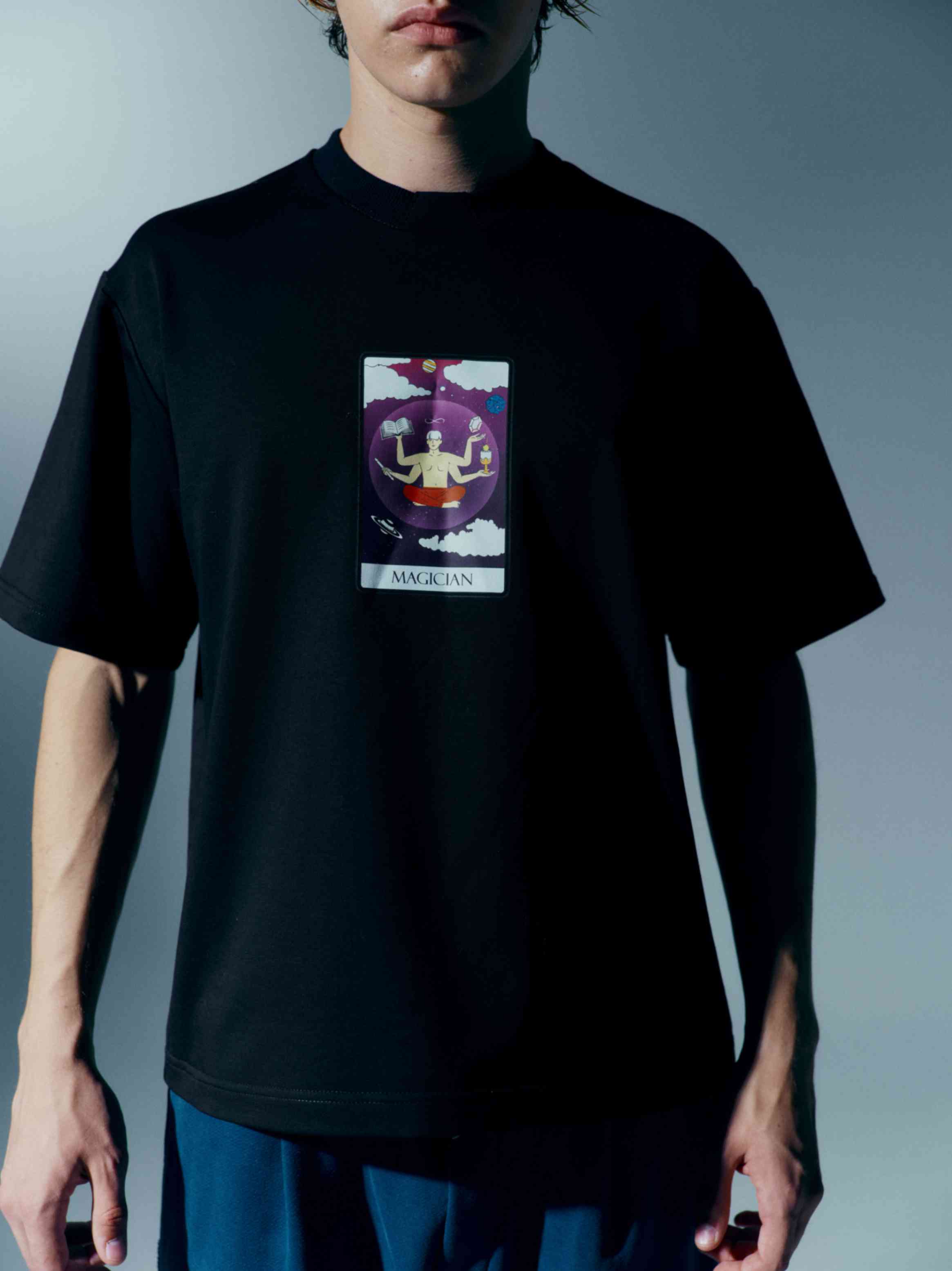 Close-up view of a unisex cotton t-shirt with a Tarot card print from the 'The Moon' collection, highlighting the captivating and enchanting design with a stand-up collar for a modern touch