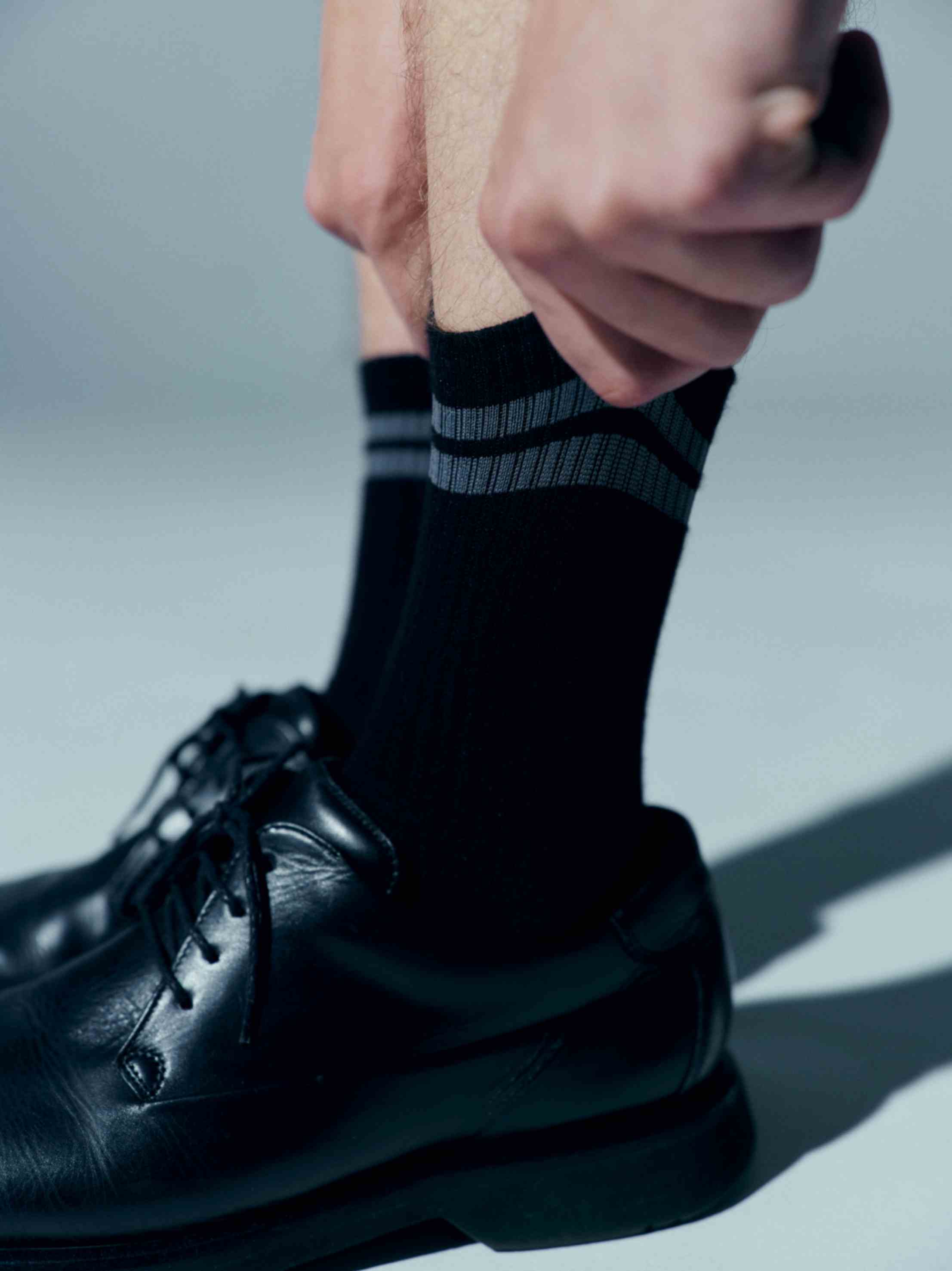 Close-up of the cotton socks laid flat, highlighting the wide stripes and branded logo for a statement accessory