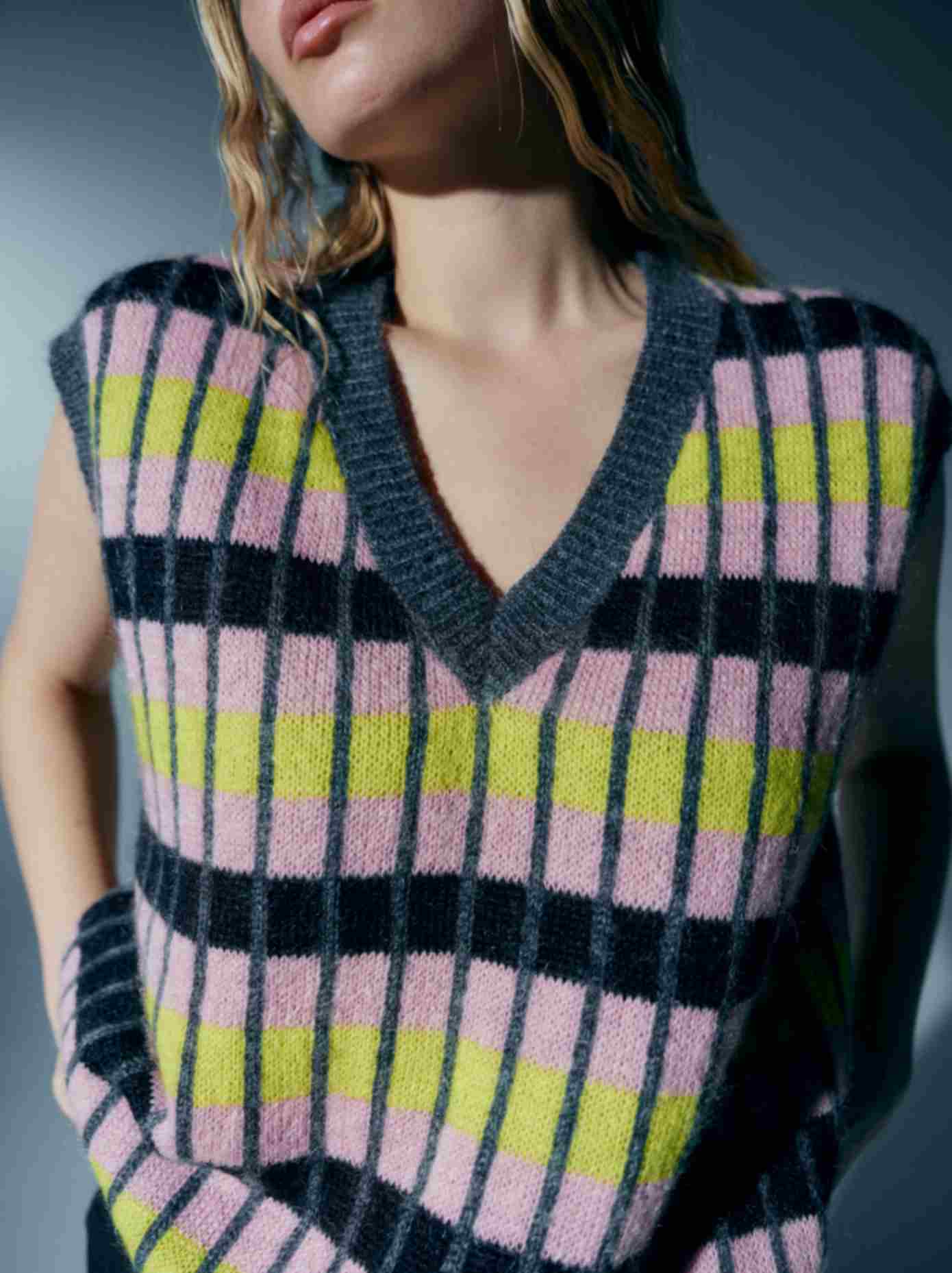Close-up of the model wearing the vest, emphasizing the softness of the kid mohair fabric